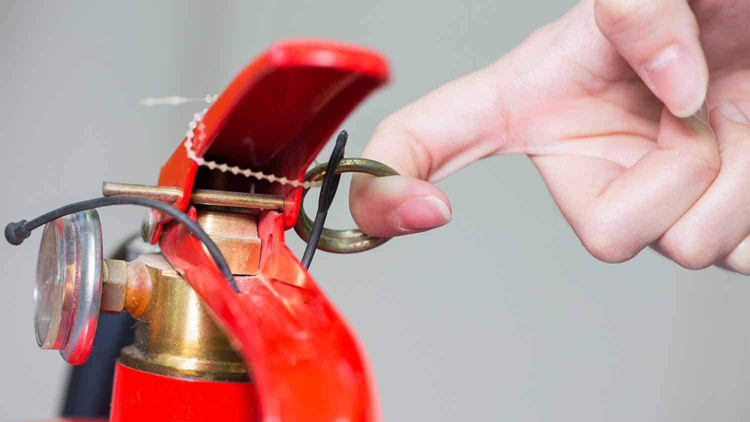 Fire extinguisher pin being pulled