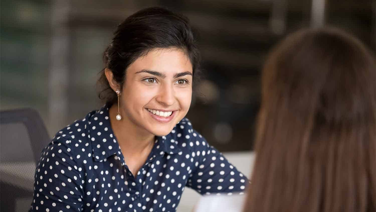 Smiling woman talking to someone