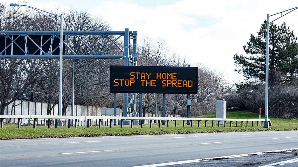 Motorway sign asking drivers to 'stay at home and stop the spread'.