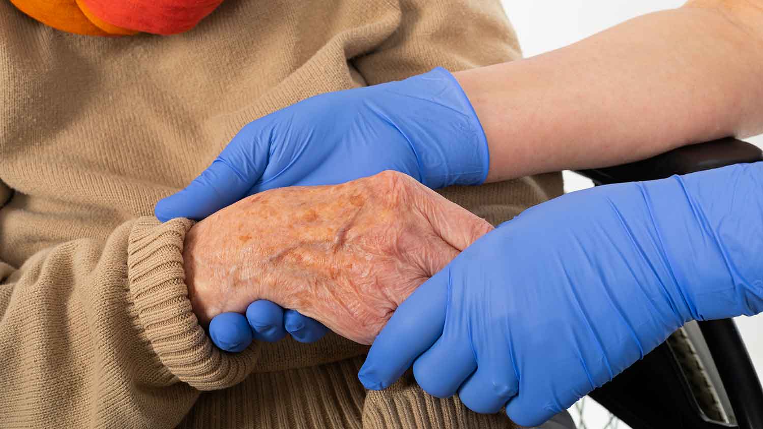 Nurse attending to a patient whilst wearing PPE