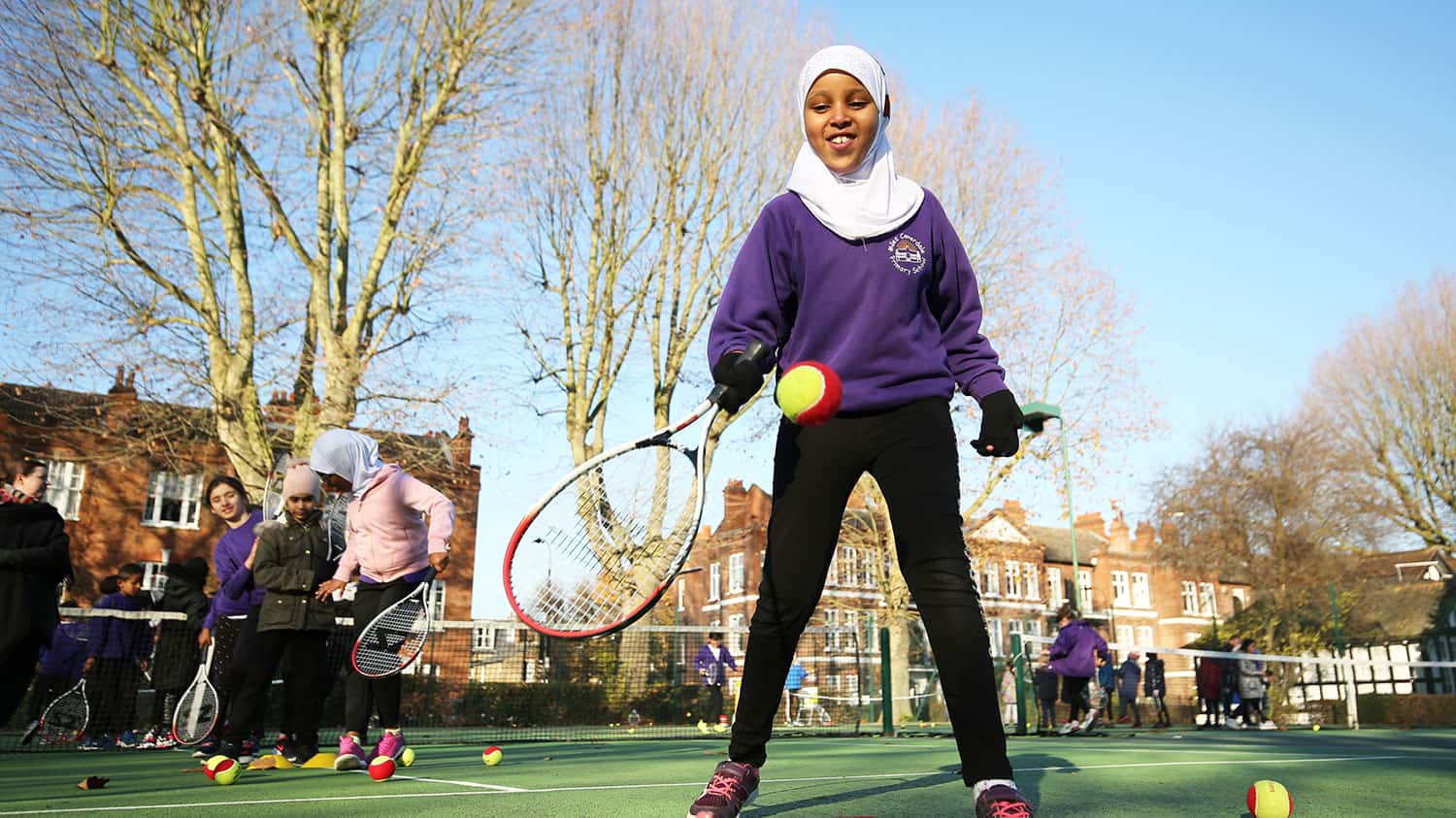 Child playing tennis