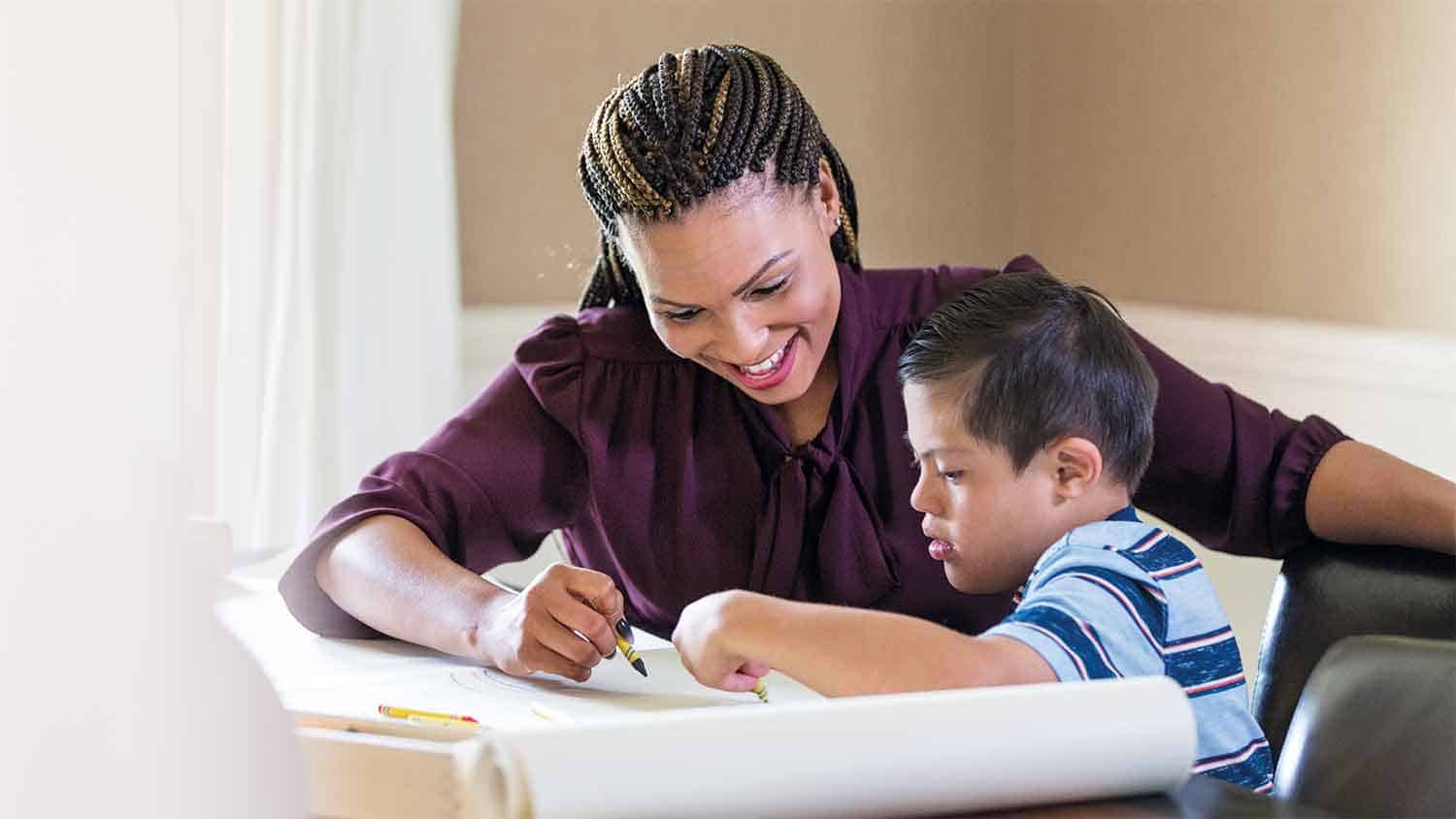 Teacher working with a young boy