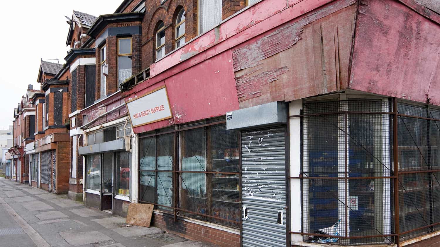 Street full of closed down shops with shutters pulled down