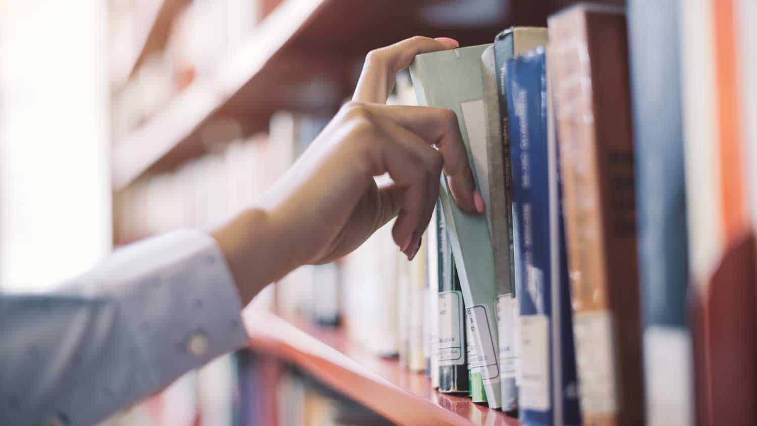 Pulling a book from a bookshelf