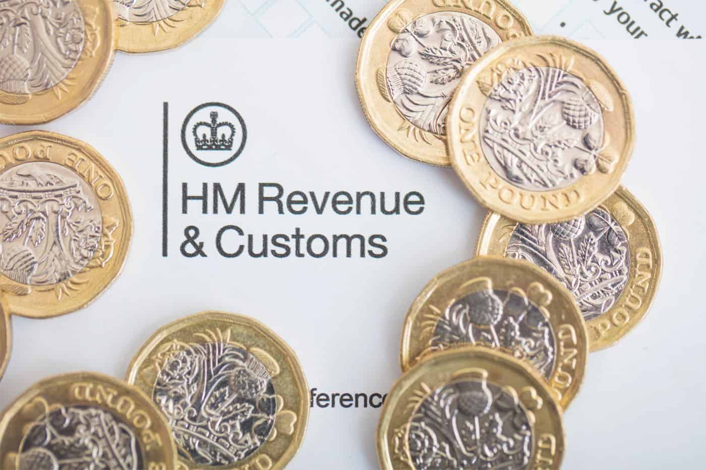 A circle of British pound coins around a HMRC letter