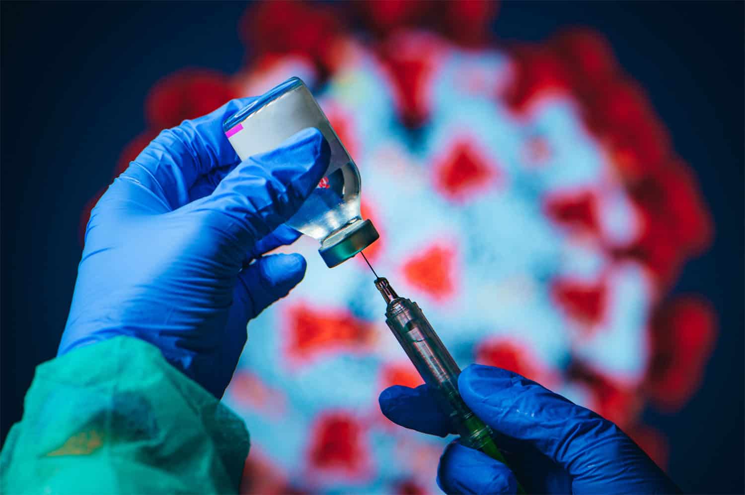 A scientist injecting the covid vaccine into a bottle