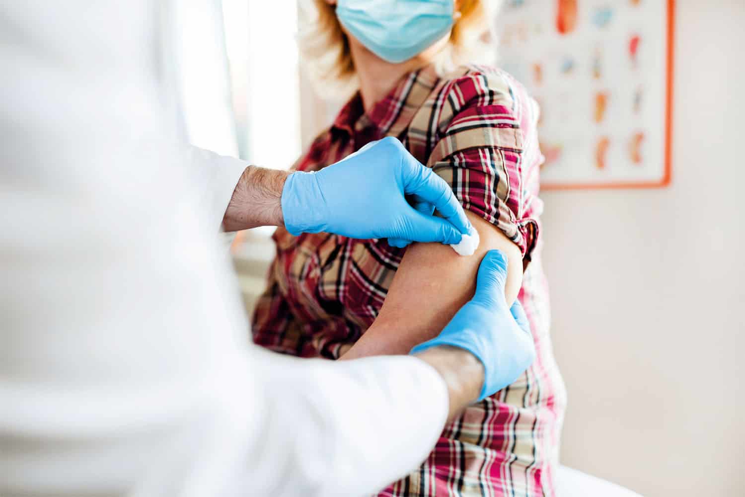 A lady wearing a mask getting the COVID vaccine