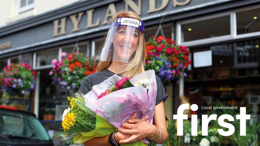 first magazine front cover picture - a florist holding flowers dressed in PPE