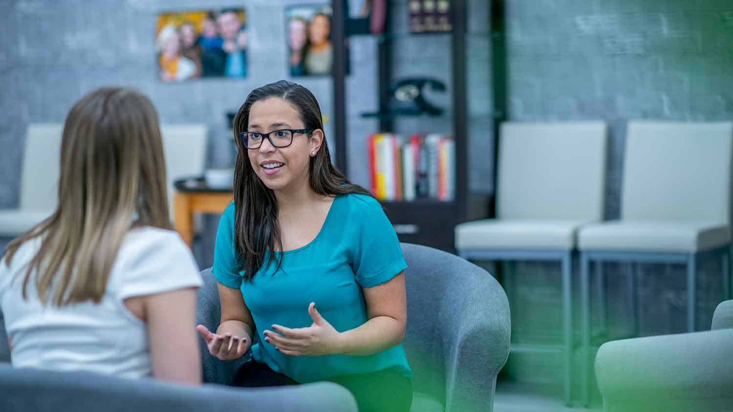 Two women talking in an office setting