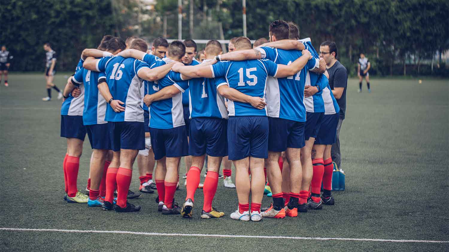 Football team in a huddle for motivation