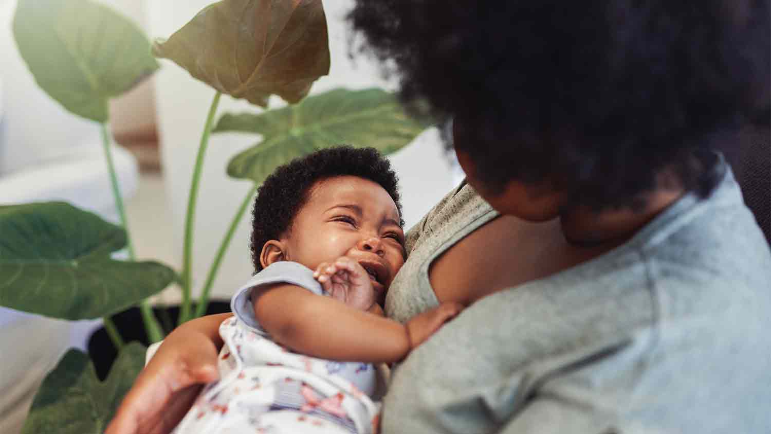 Baby crying in its mothers arms