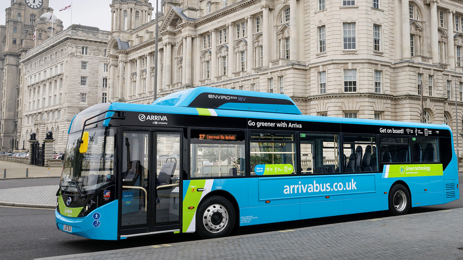 A blue bus arrives outside an old building in Liverpool