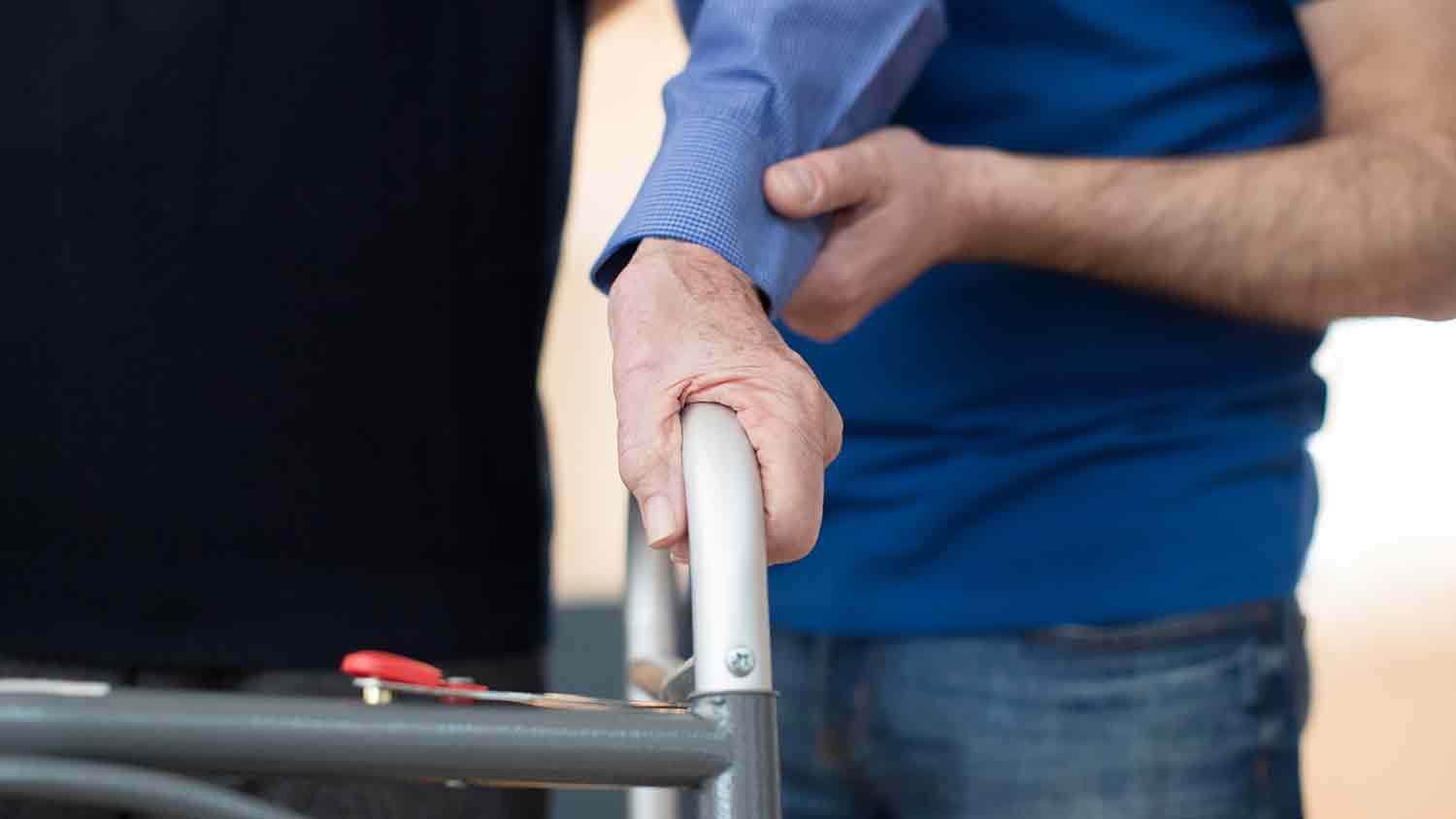 Man walking with a zimmer frame.