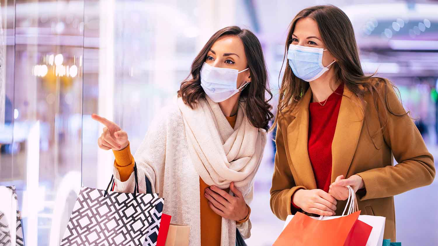 Two women out shopping both wearing PPE masks