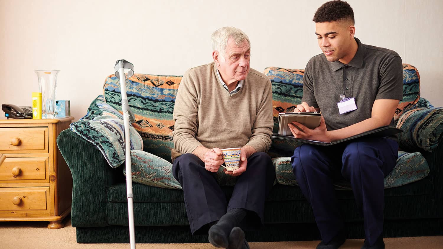 Man sat next to his carer