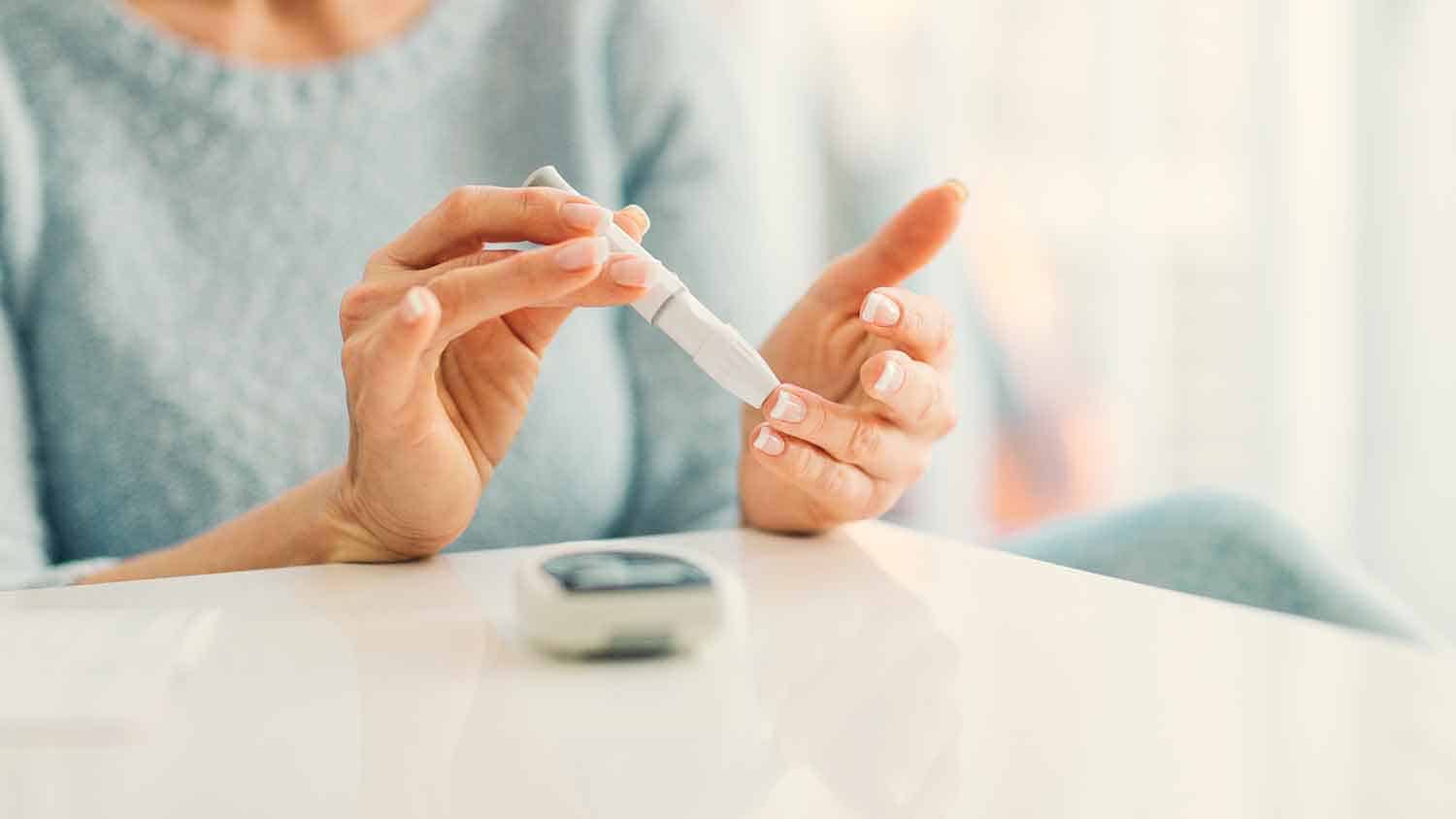 Woman testing her own blood sugar levels