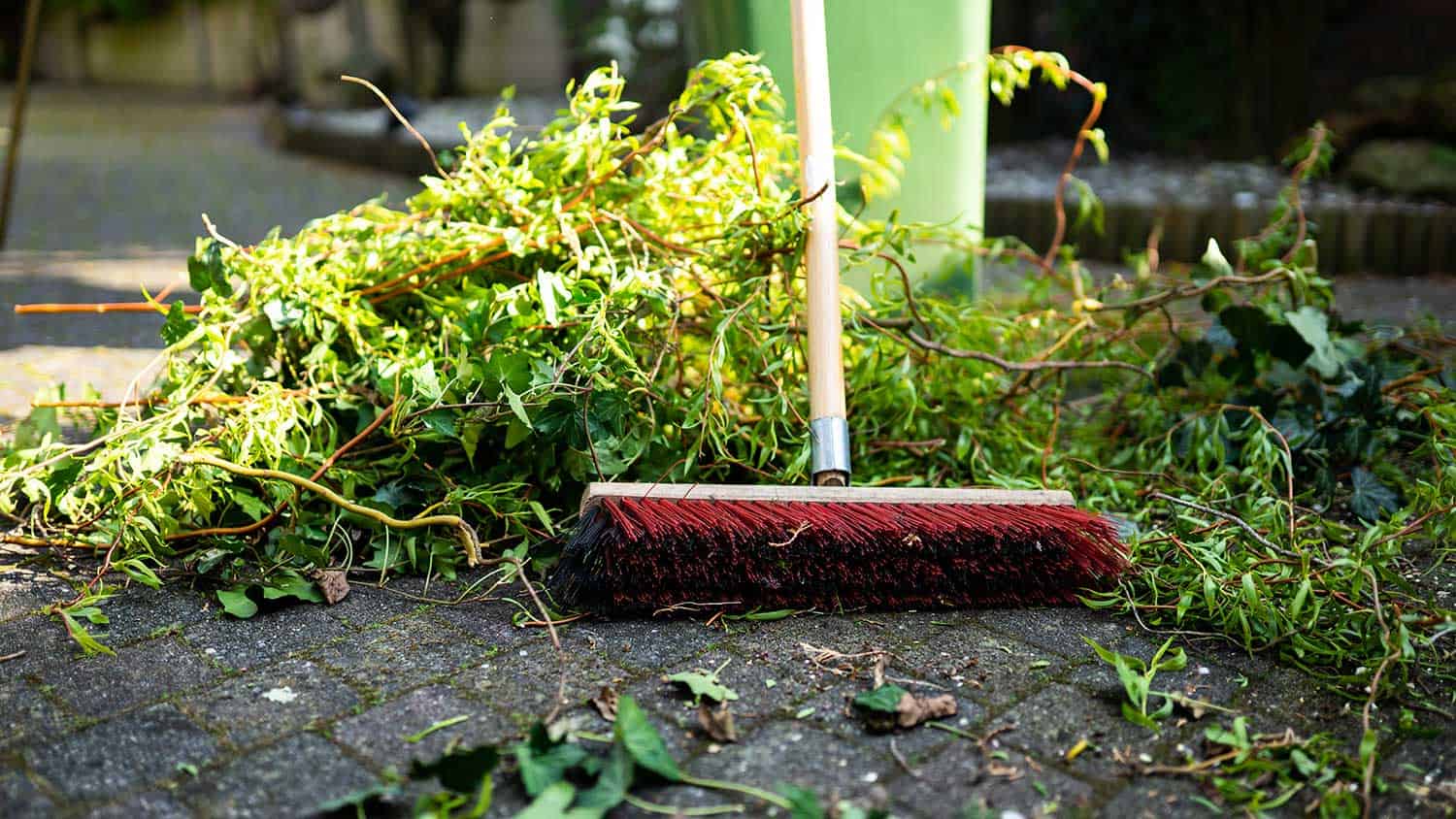 Broom lying next to garden waste