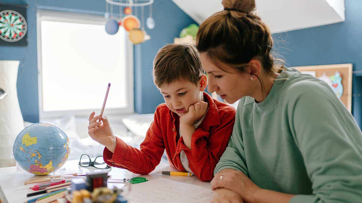 Mother helping her child with homework