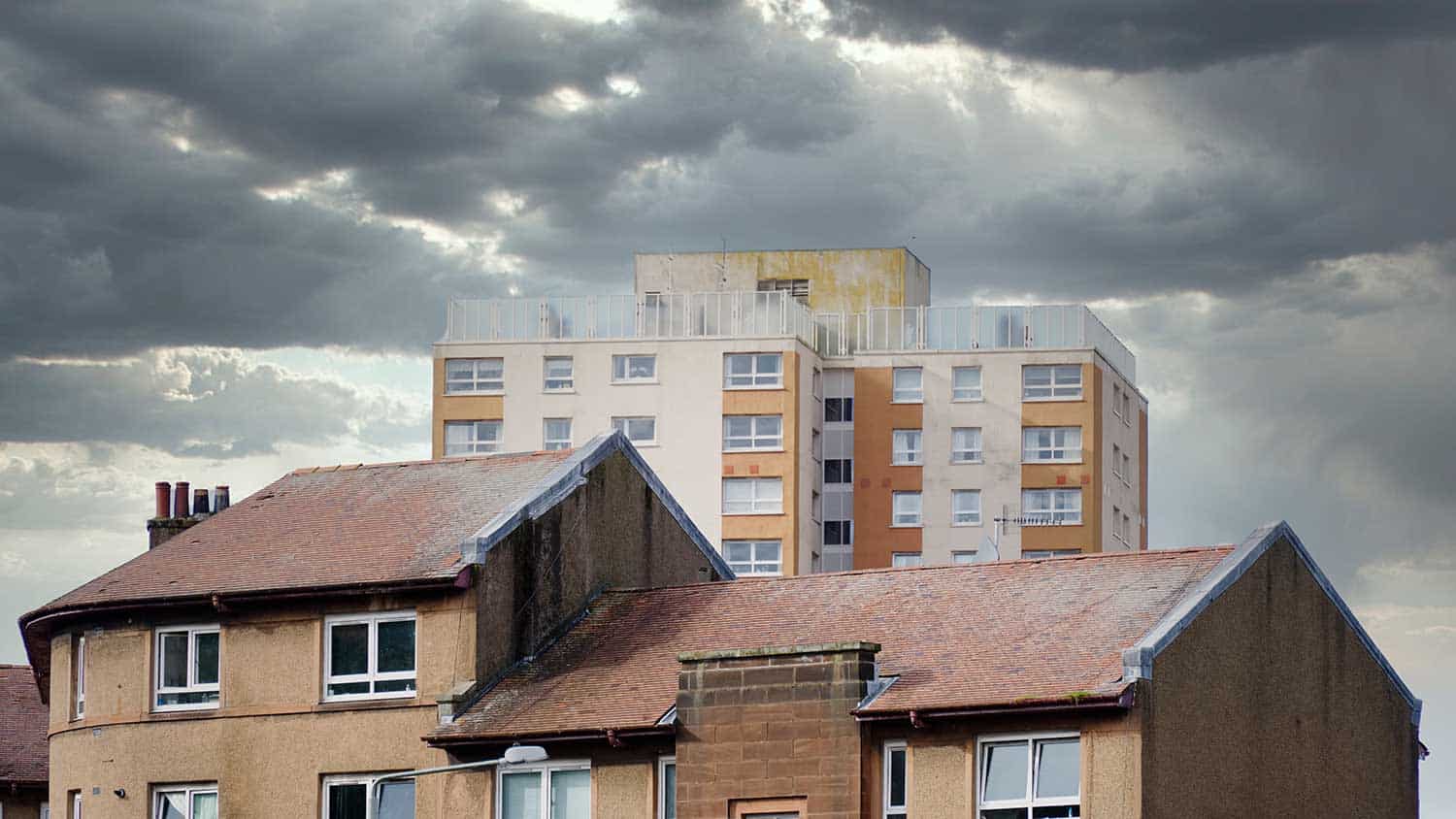 Block of flats towers ominously over houses