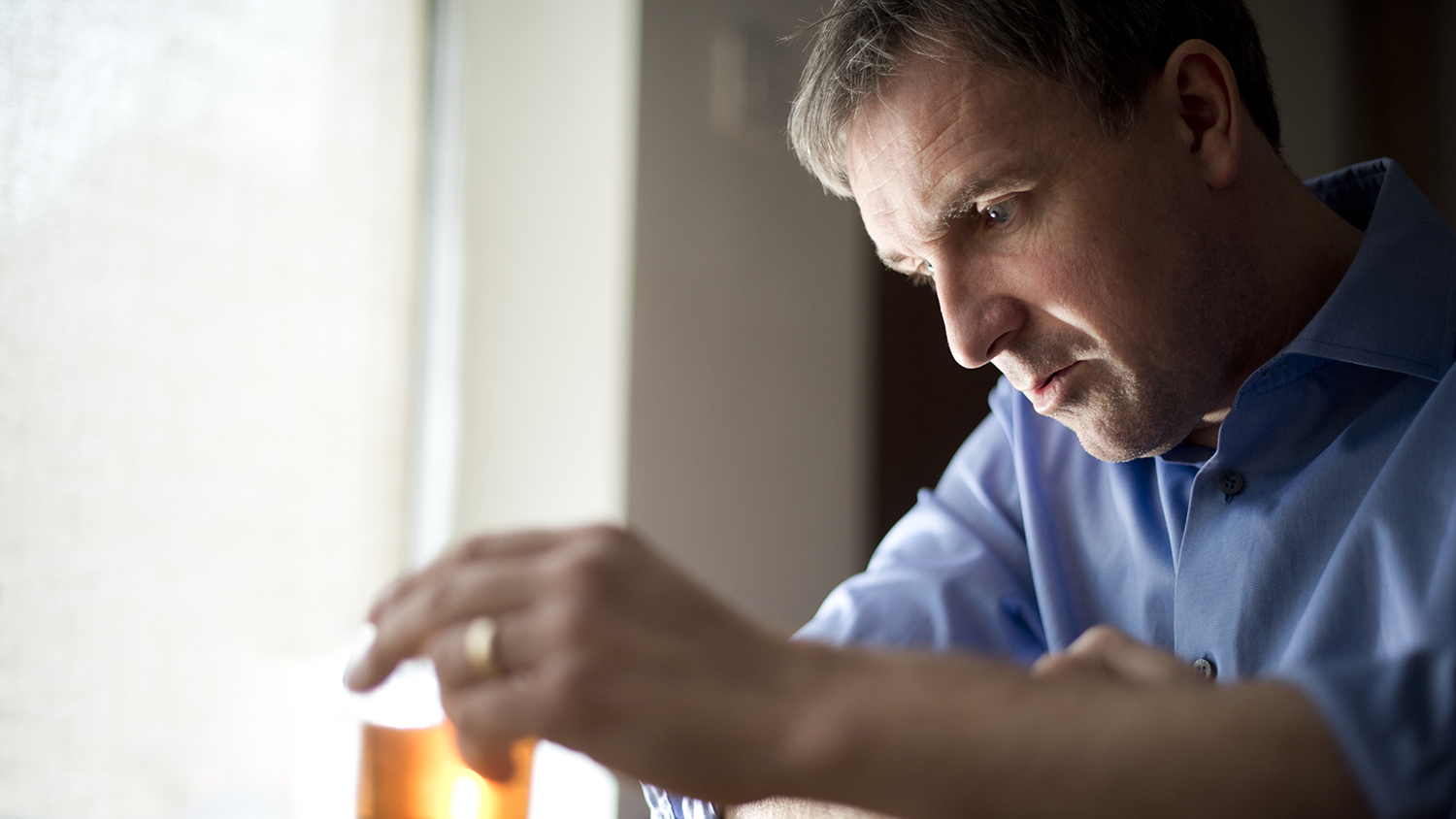 Man with an alcoholic drink looking depressed