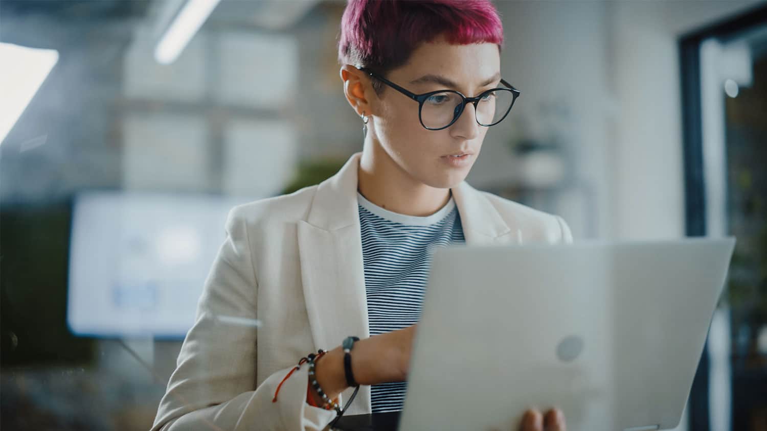 Young person looking at their laptop