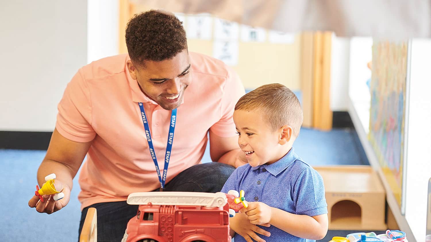 Teacher chatting to a toddler