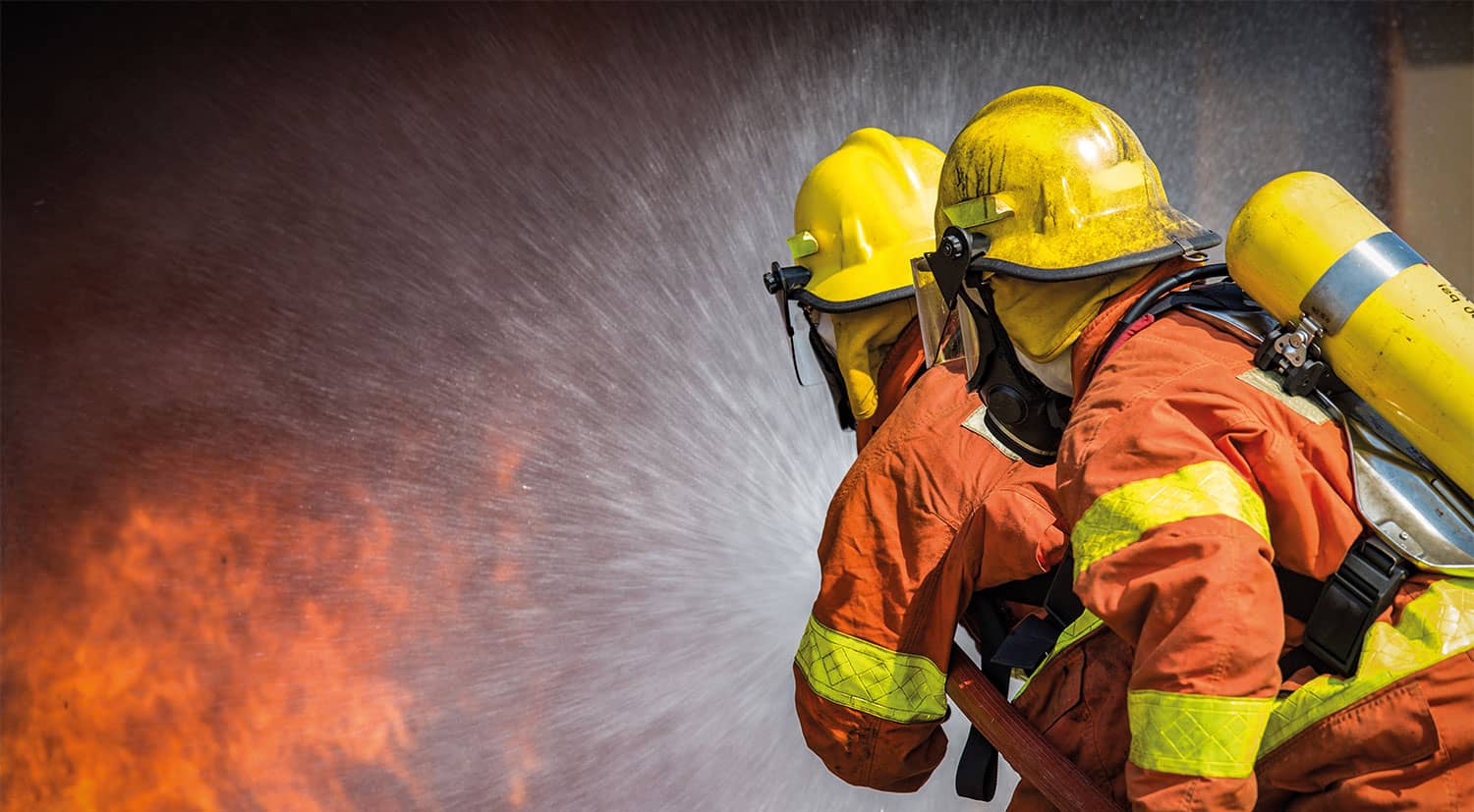 Two firefighters putting out a fire