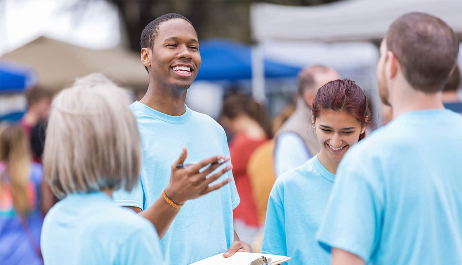 Young people standing around laughing