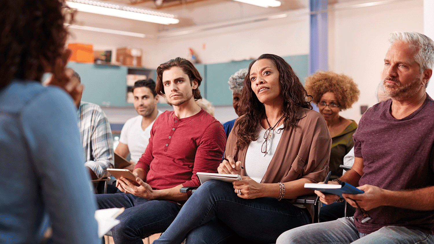 Group of people taking notes of a seminar