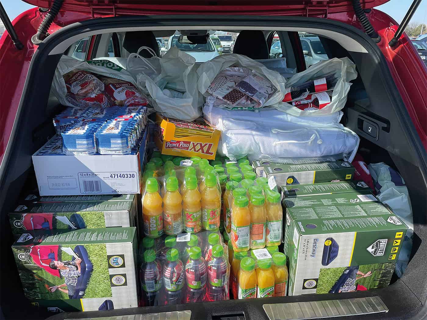 A packed car boot filled with supplies