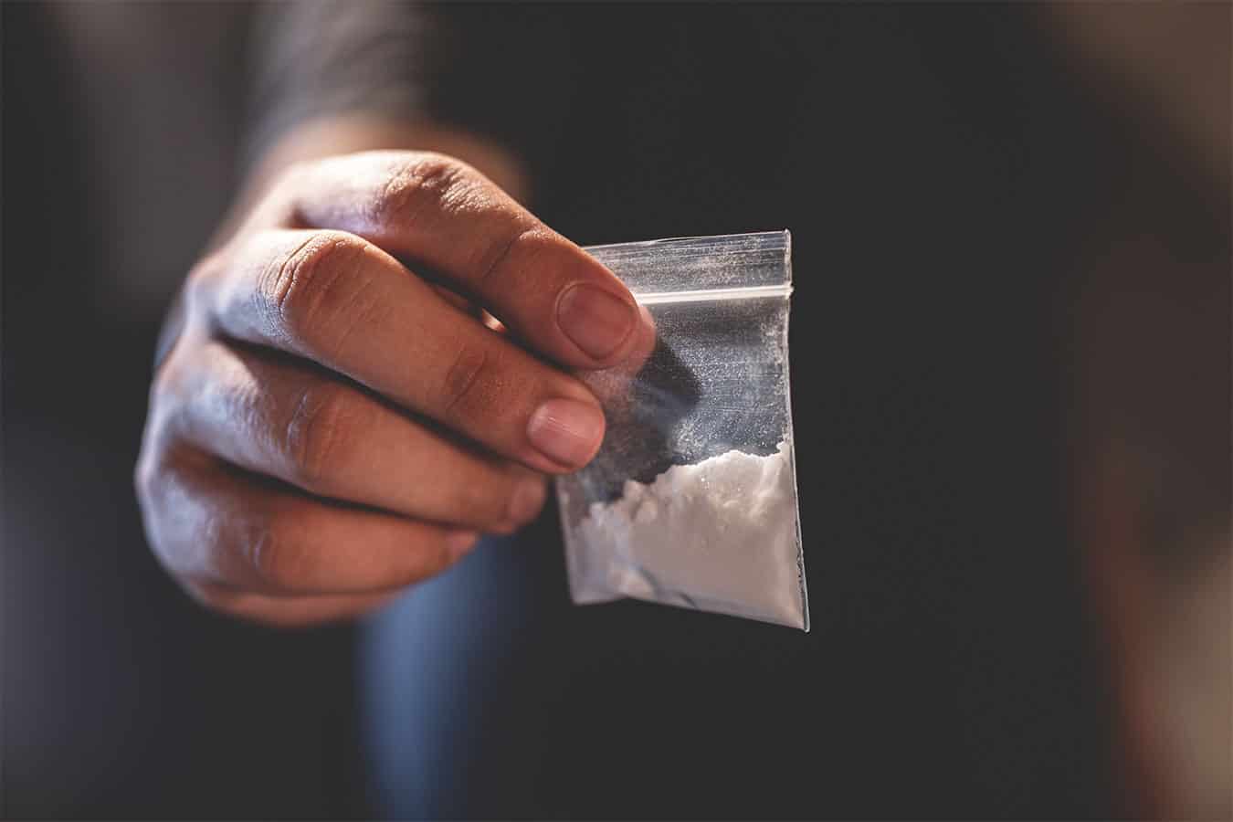 Someone holding a bag of drugs
