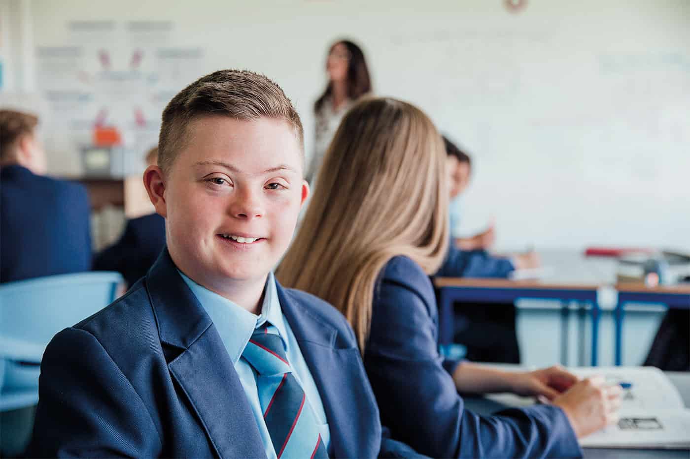 Young boy with down syndrome at school