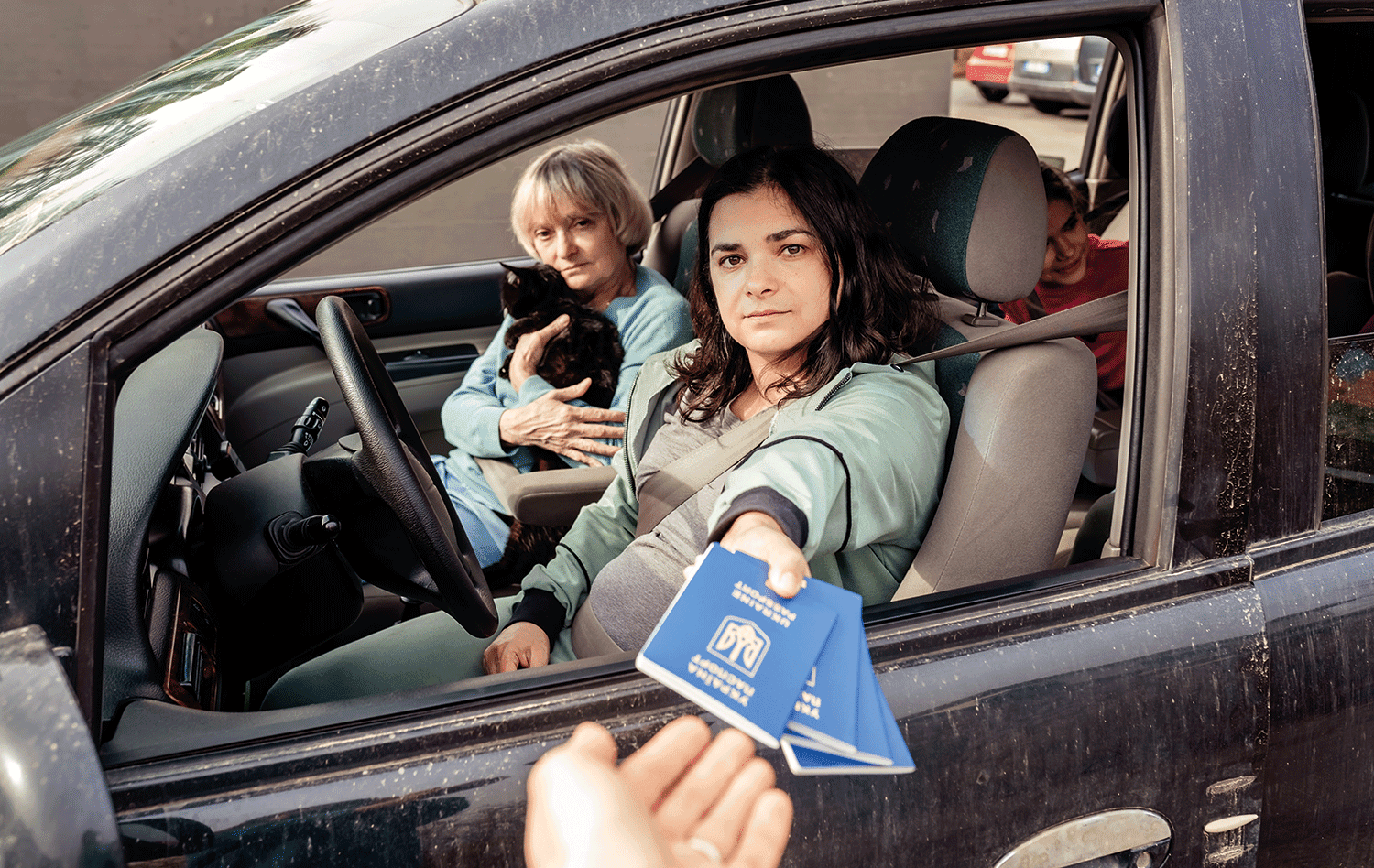 woman showing a passport from a car