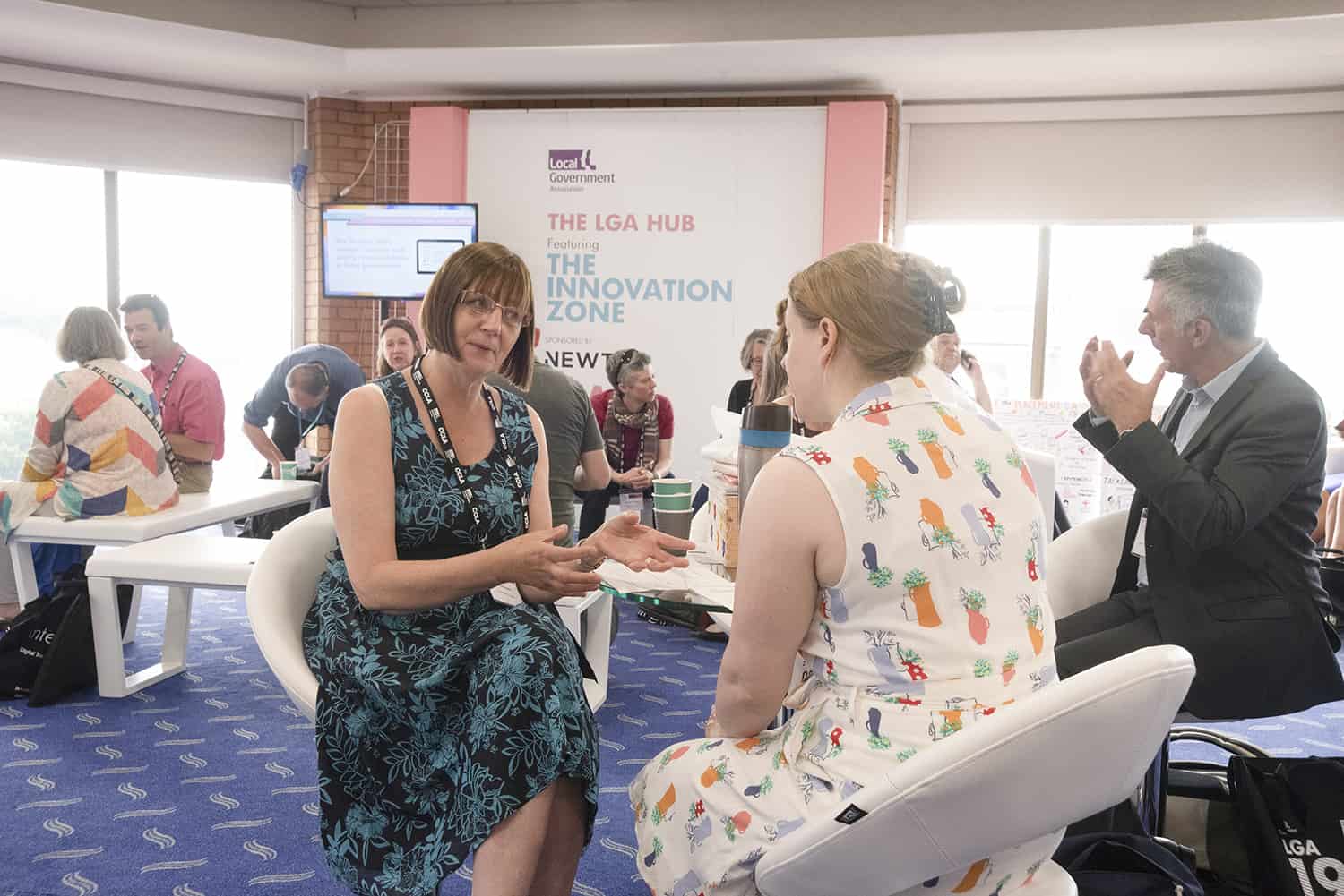 Female delegates talking to each other in Innovation Zone at LGA Conference
