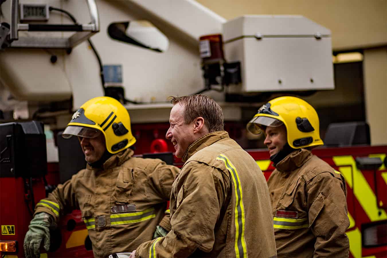 Firefighters stood by a fire engine