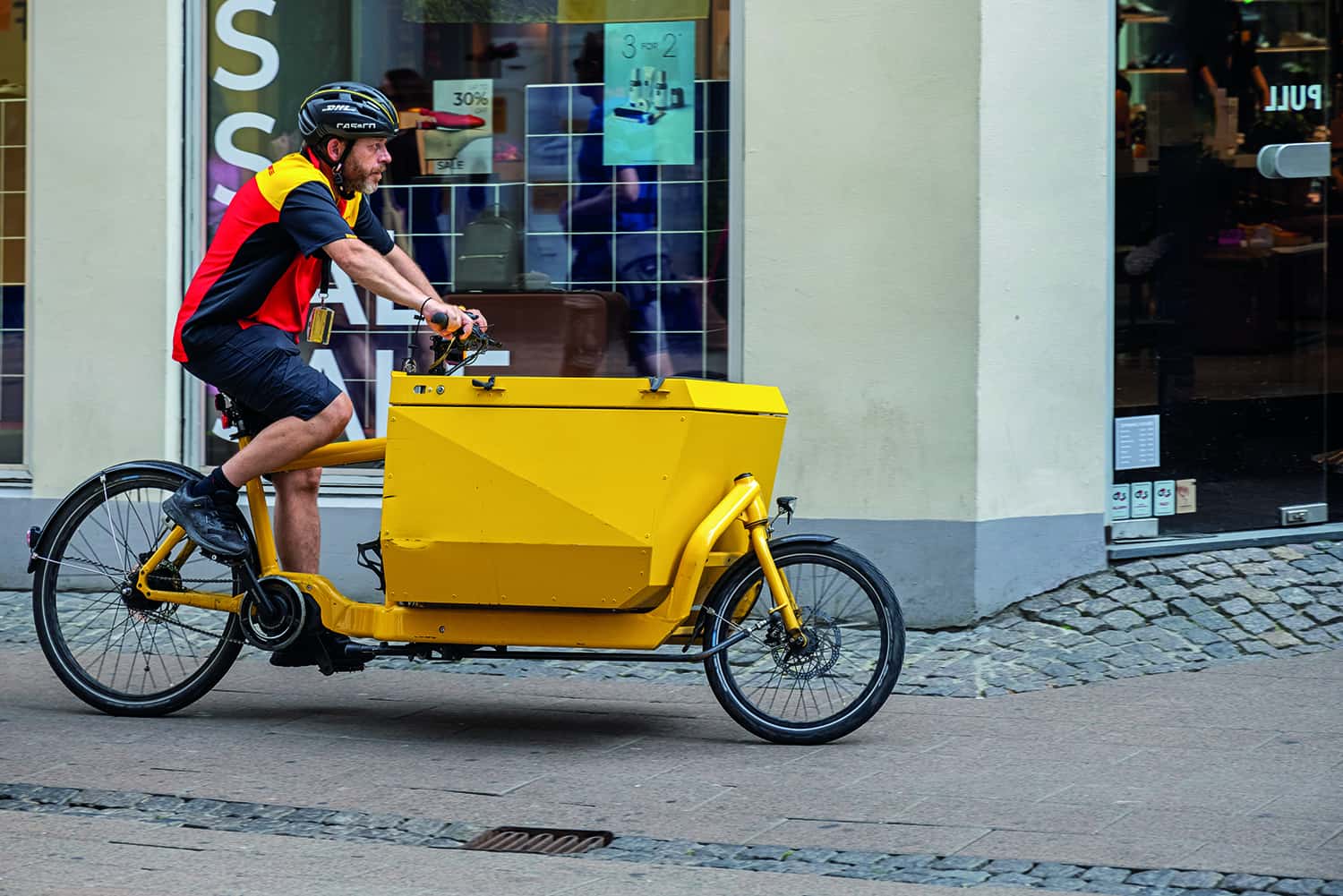 Parcel delivery service man at a cargo bike