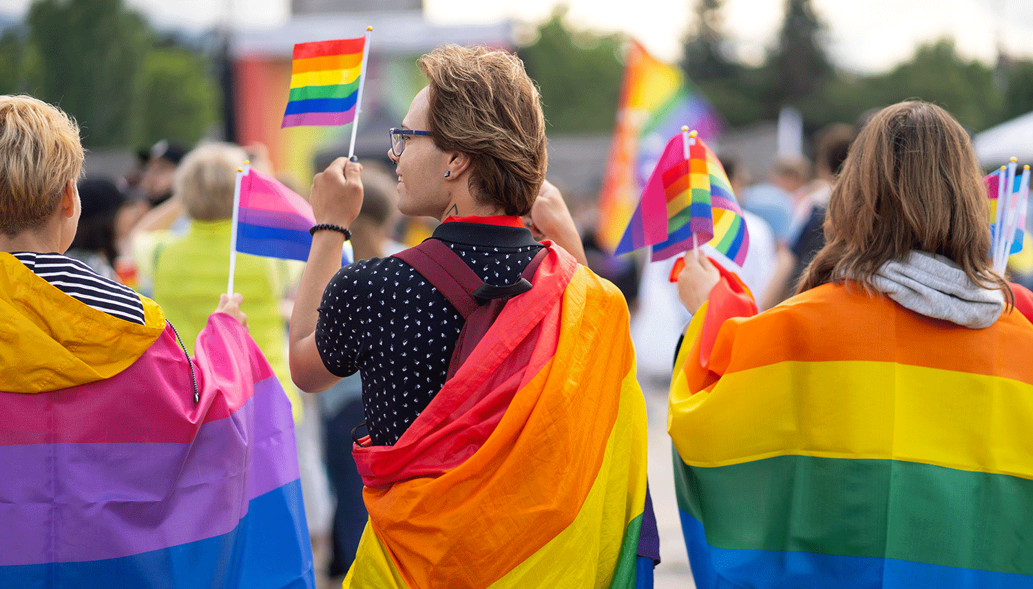 LGBTq community wearing rainbow flags