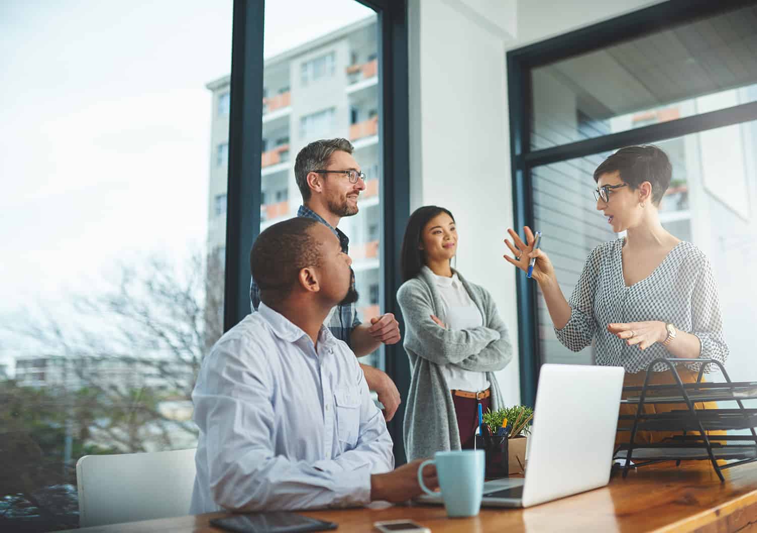 Group of colleagues having a discussion in a modern office