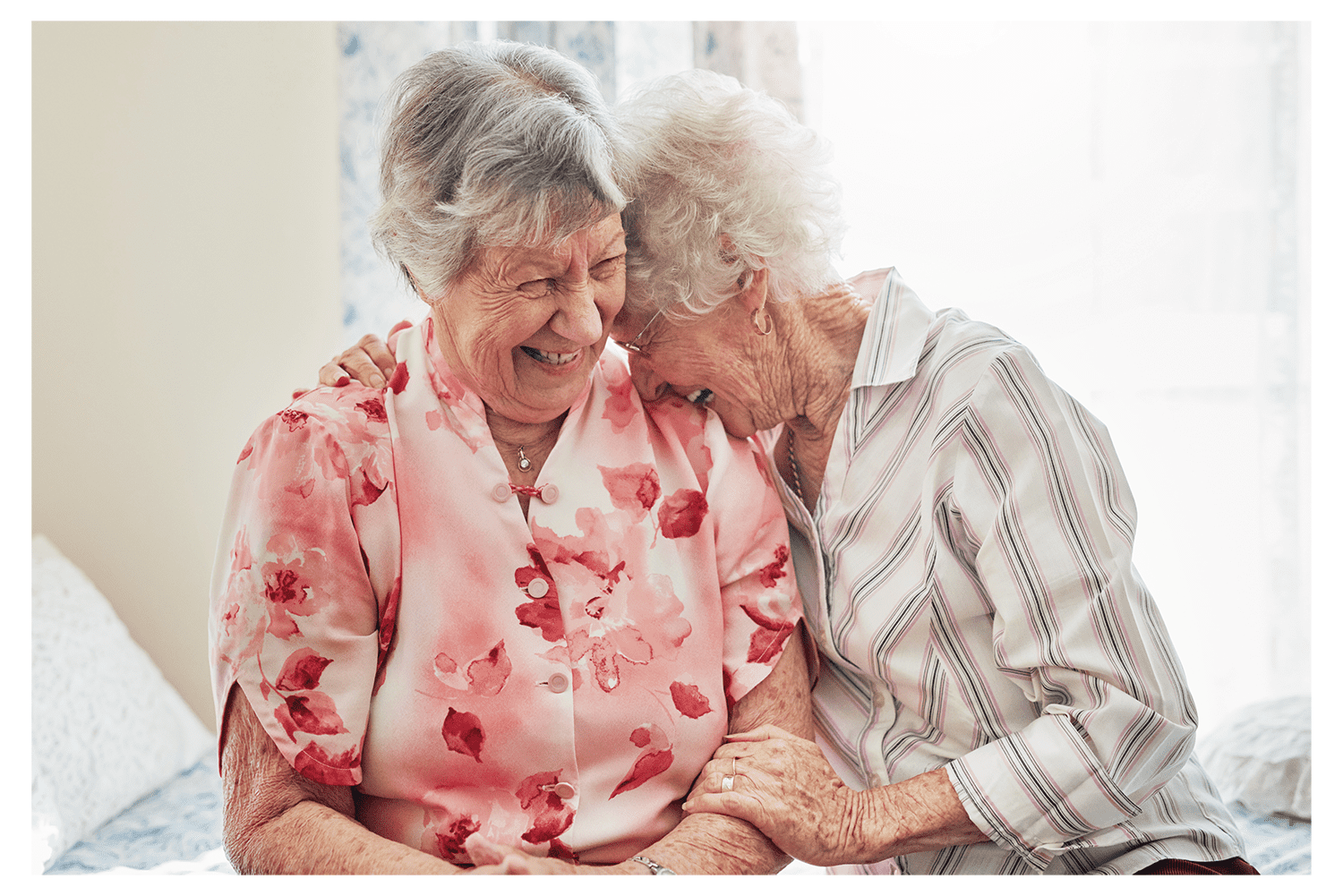An elderly couple laughing