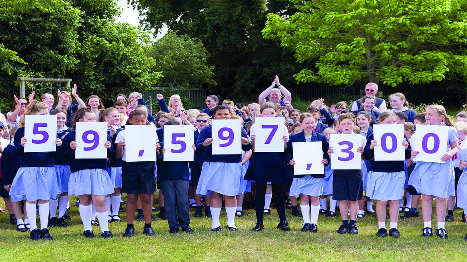 Pupils from St Alban's Primary School in Havant hold up numerical placards to unveil the Census 2021 population of England and Wales