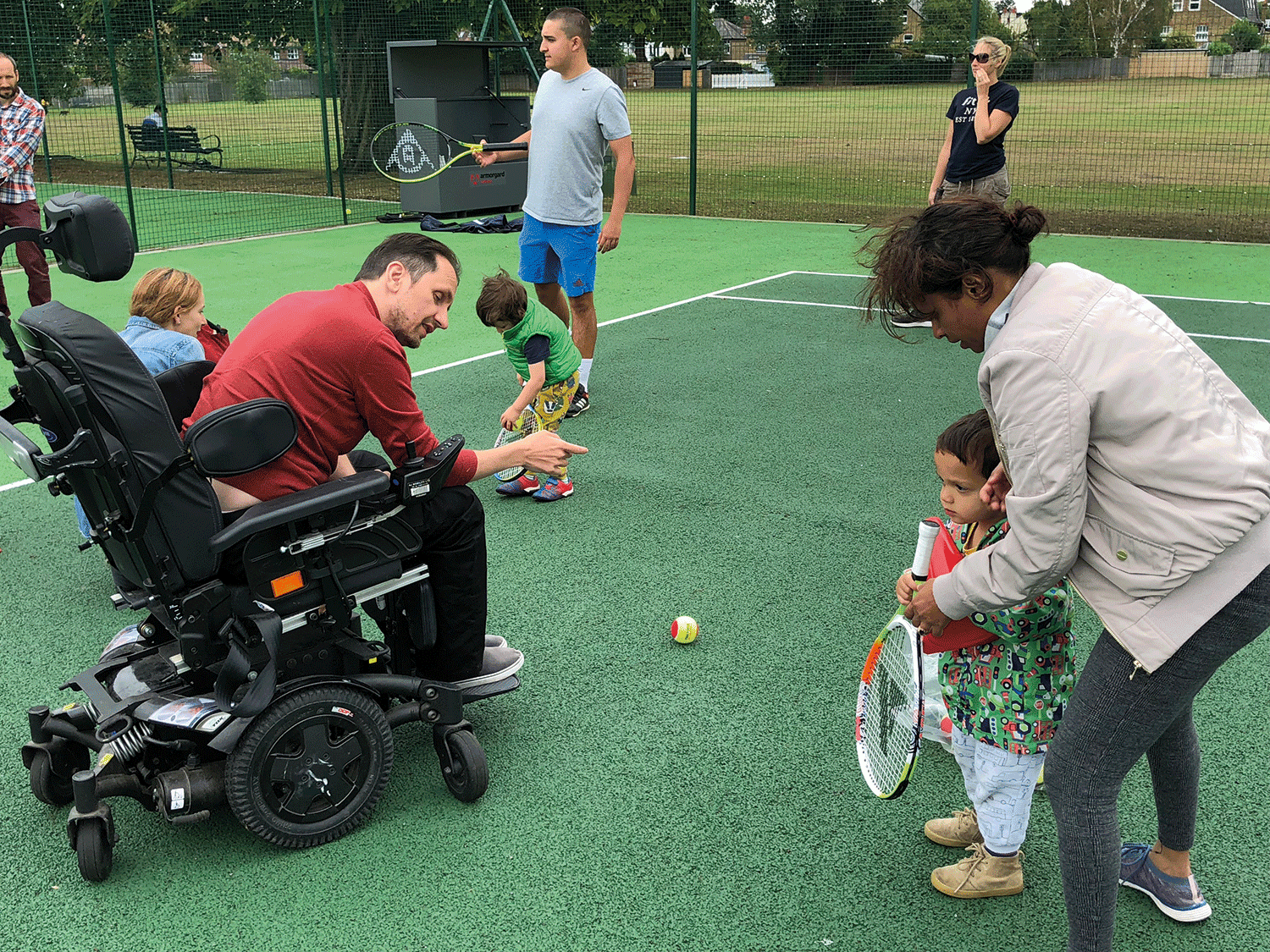 person in a wheelchair playing tennis