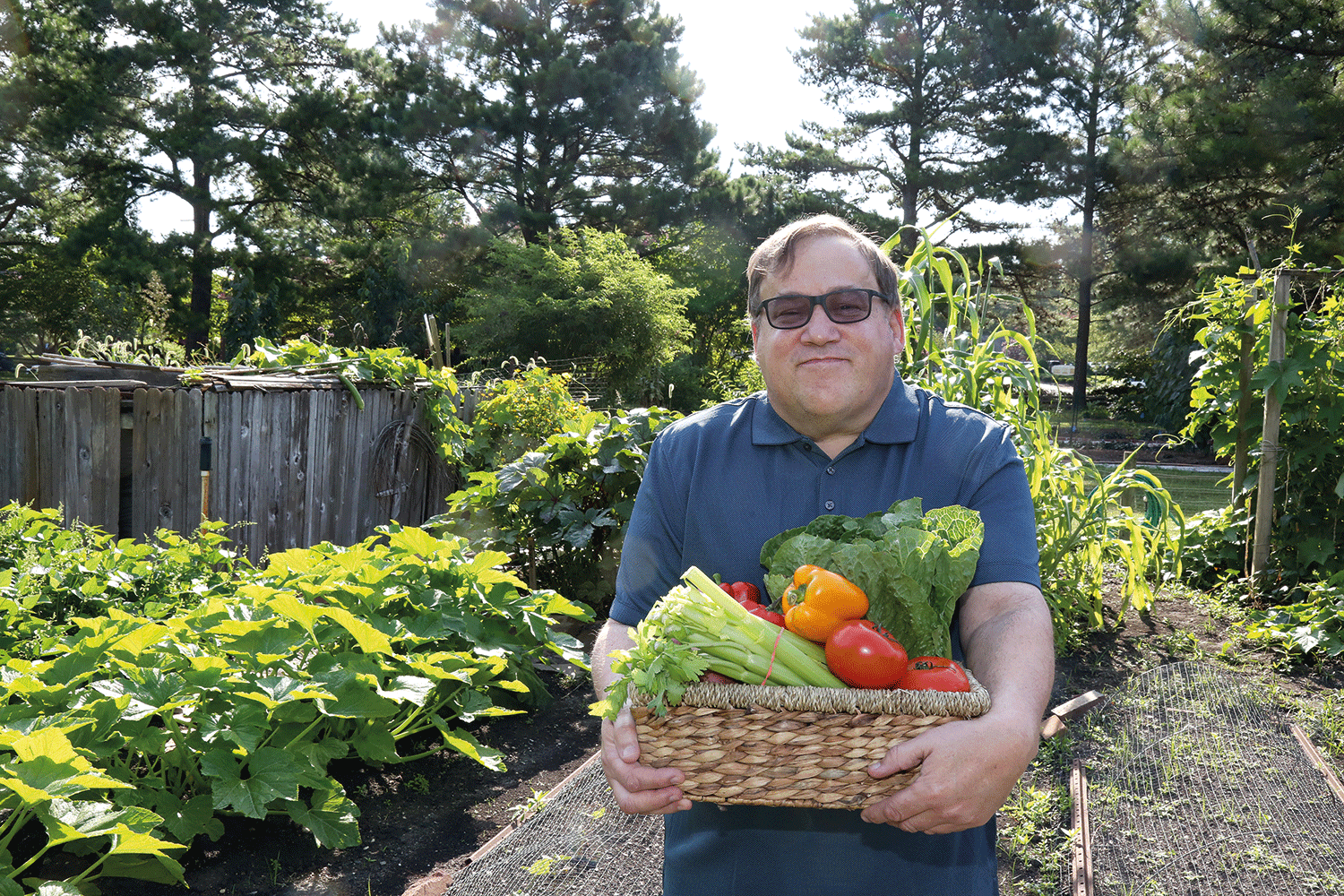 man holding a basket of vegetables