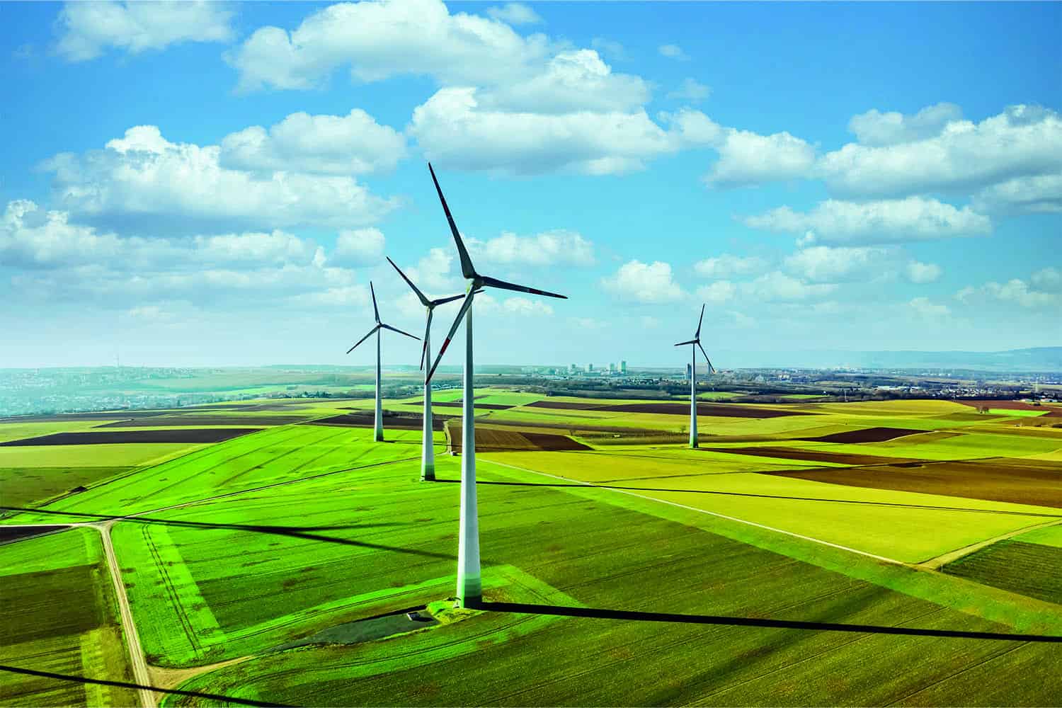 three windmills in fields
