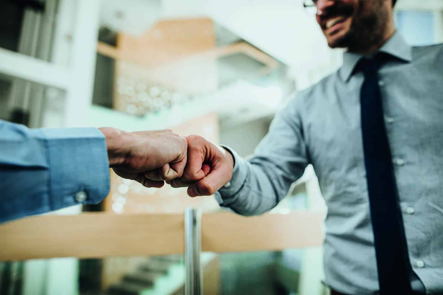 two businessmen bumping fists