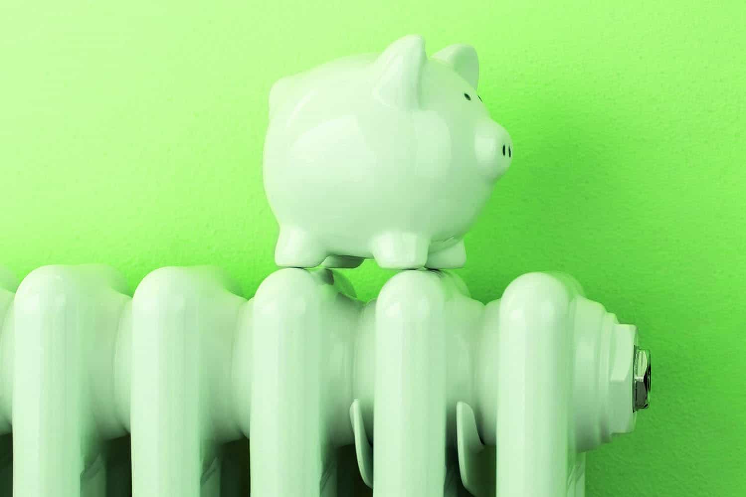 piggy bank on radiator against green background