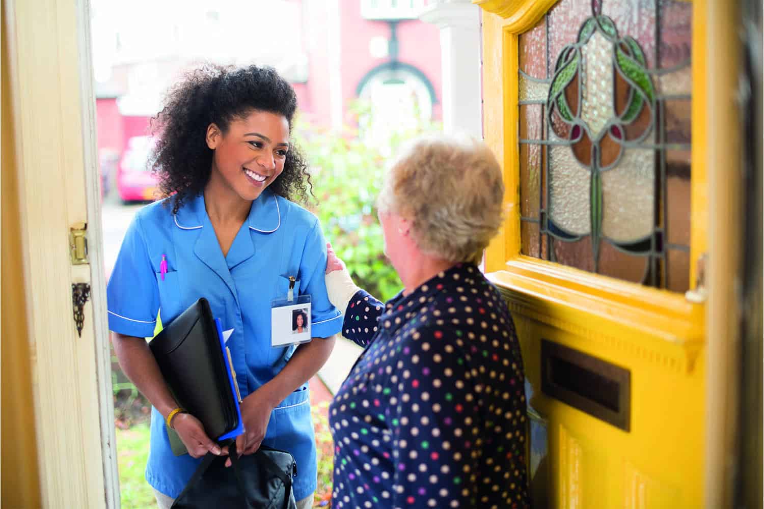 Smiling female care worker with older woman