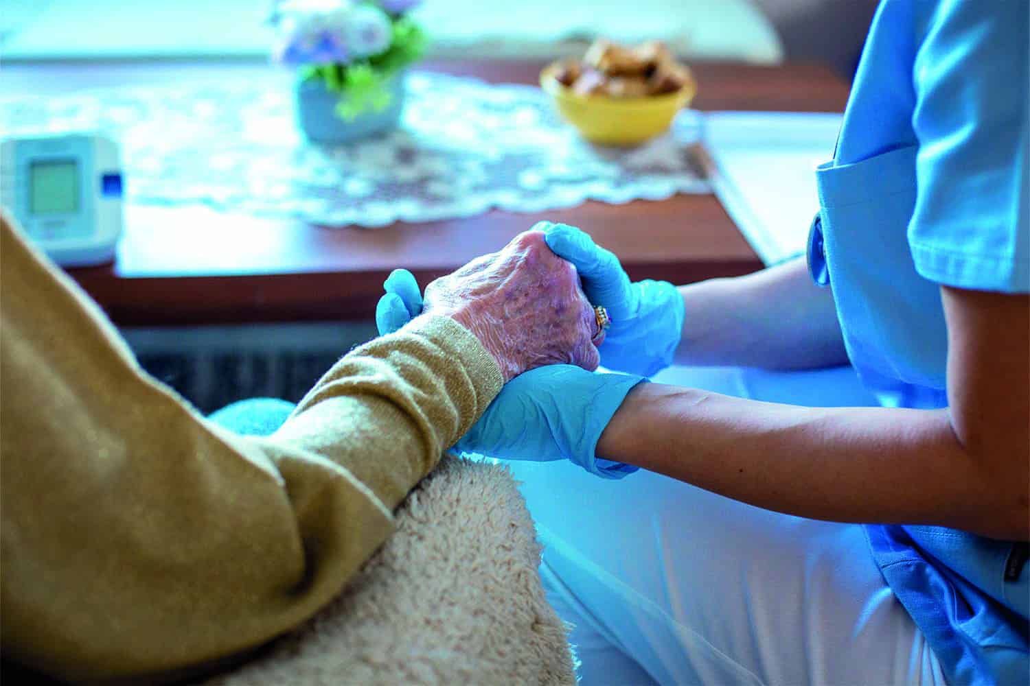 Carer holding older person’s hands