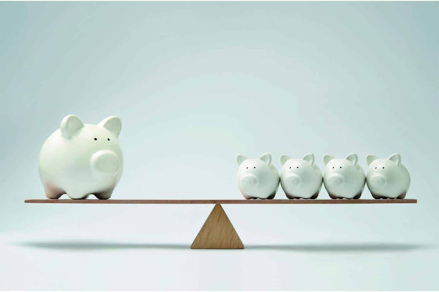 : large white piggy bank balancing four small white piggies on wooden see-saw