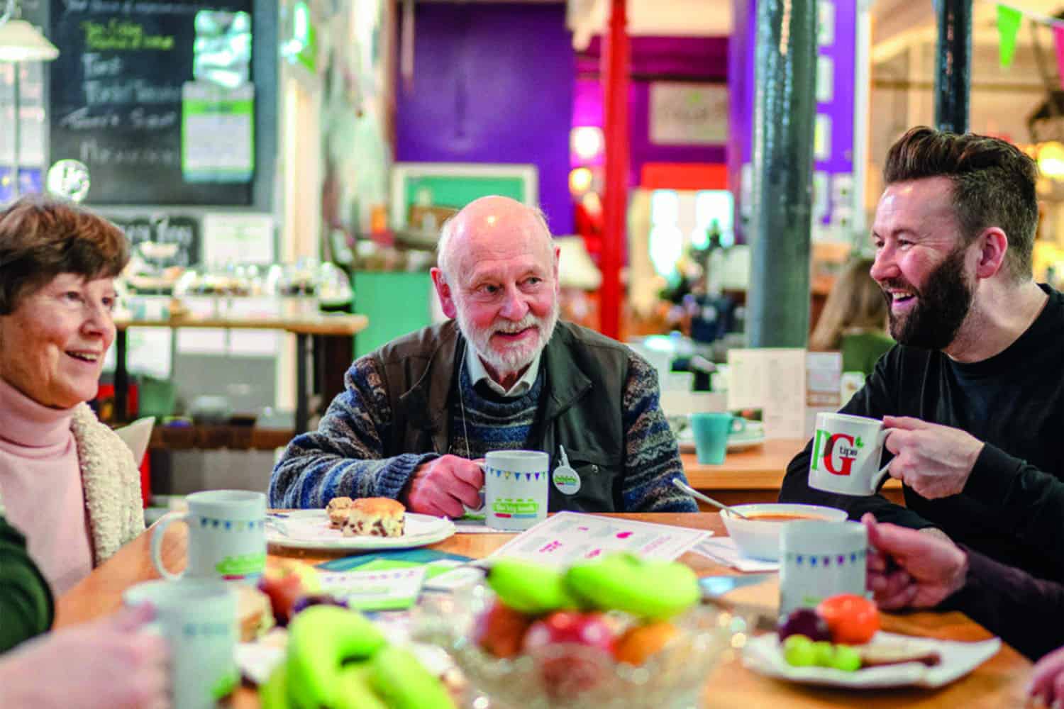 people sitting around table enjoying tea and lunch