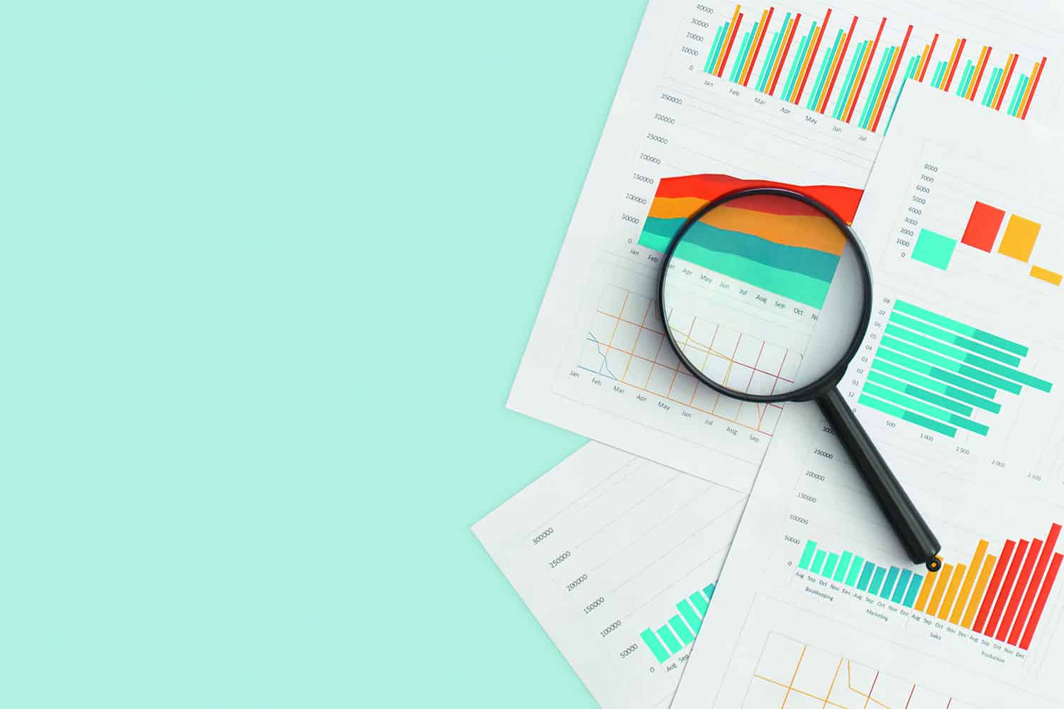 magnifying glass on coloured graphs and charts